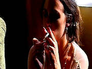 Busty Brunette Smokes And Poses