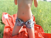 Busty Brunette Masturbating In The Grass