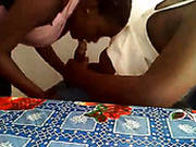 Haitian Housewife Is Serving Her Husband In A Kitchen