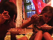 A Couple Is Eating On A Bed