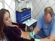 Hot Brunette Gets Tattooed For Some Cash