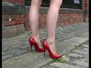Sexy High Heeled Woman Walking On Cobbles Wearing Thin Red Stilettos