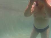 A Couple Is Swimming In The Pool